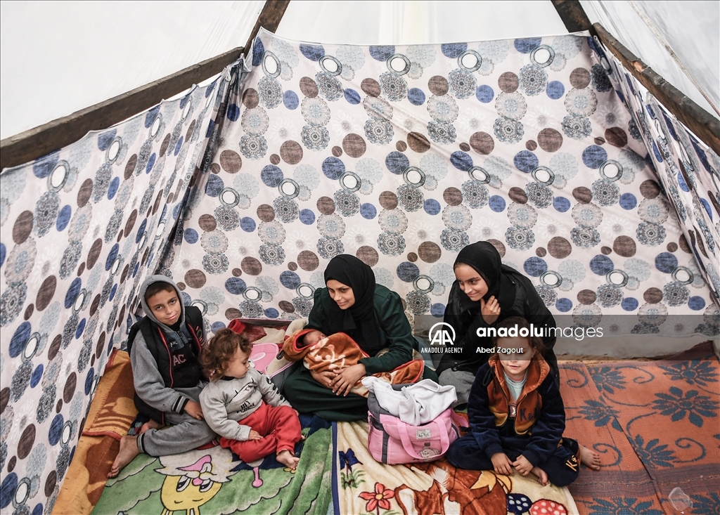 Gazan mother with her baby lives in a tent under difficult conditions in Rafah