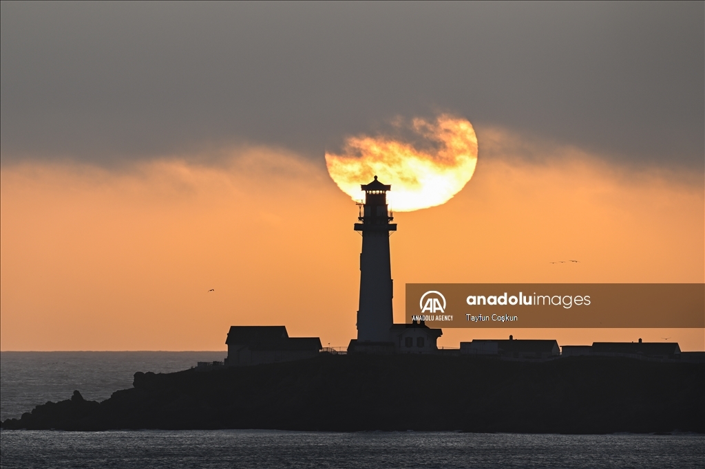 Sun sets behind the Pigeon Point Lighthouse in California
