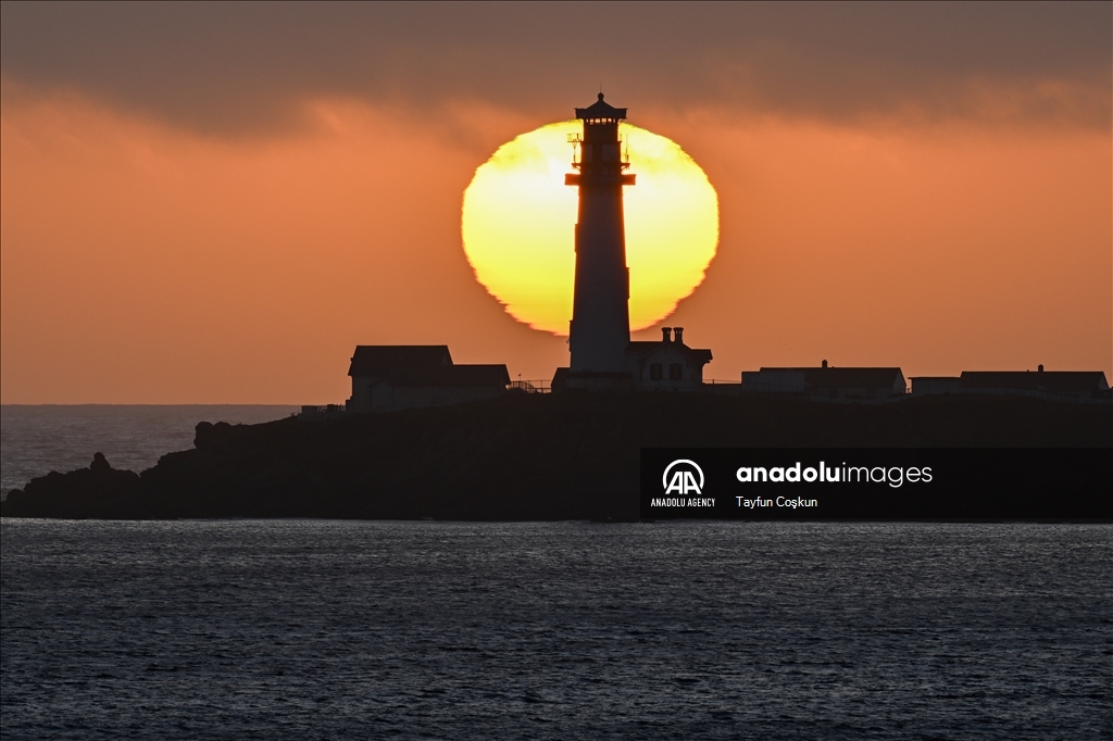 Sun sets behind the Pigeon Point Lighthouse in California