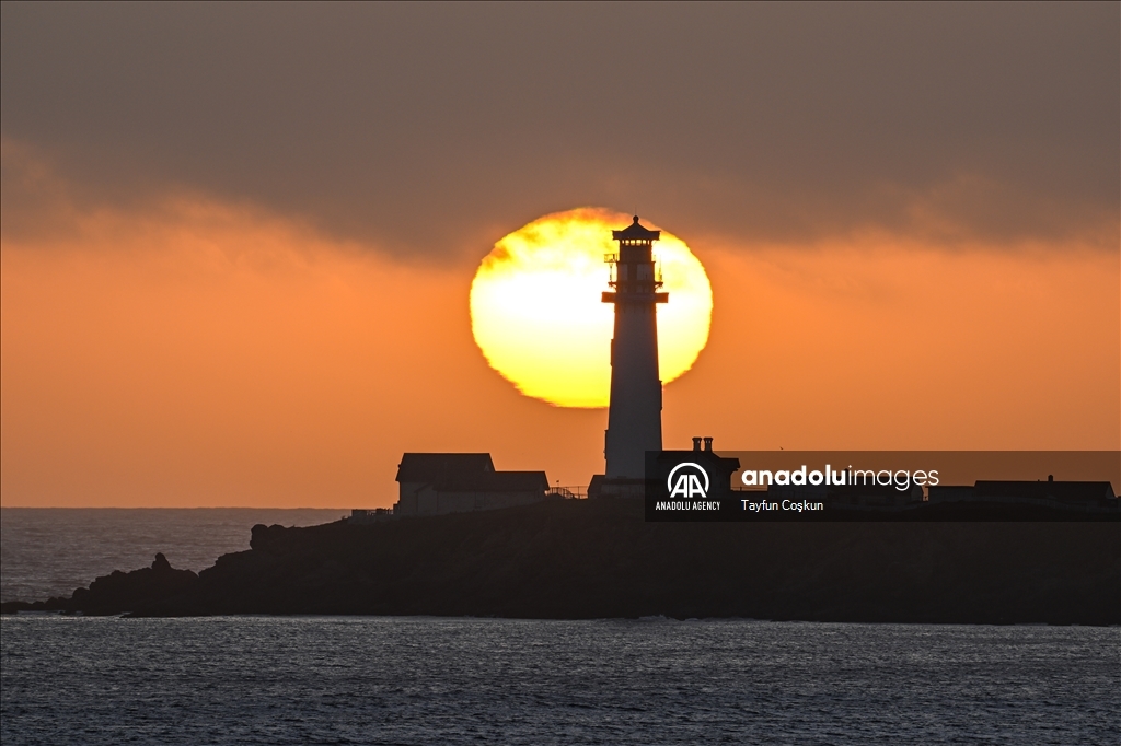 Sun sets behind the Pigeon Point Lighthouse in California