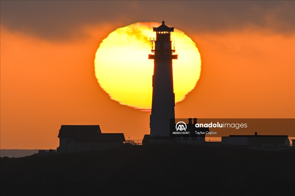 Sun sets behind the Pigeon Point Lighthouse in California
