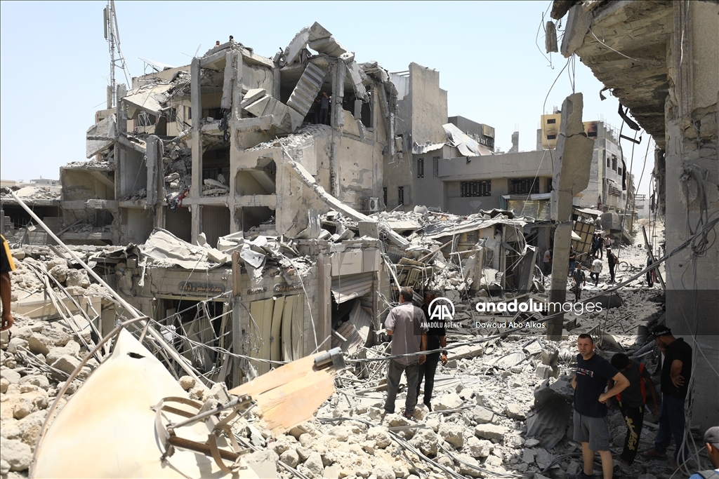 Palestinians inspect the area following Israeli attack on Gold Market in Gaza