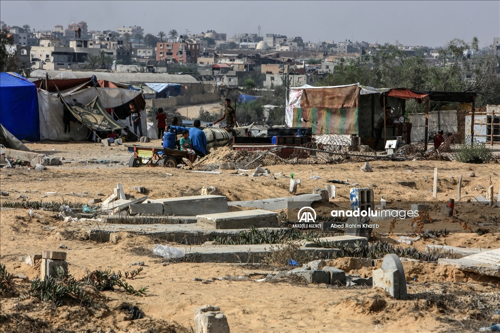 Gazan families fleeing Israeli attacks live in a cemetery