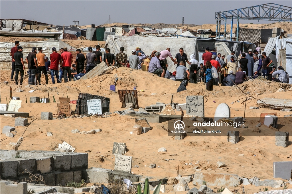 Gazan families fleeing Israeli attacks live in a cemetery