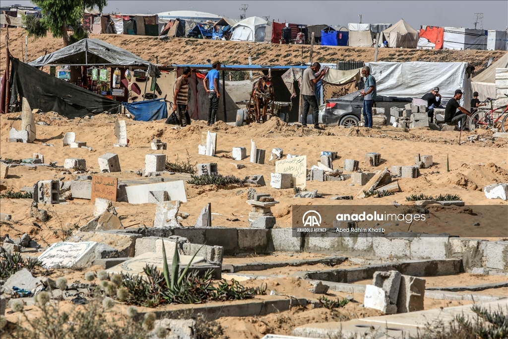 Gazan families fleeing Israeli attacks live in a cemetery