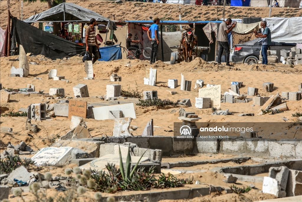 Gazan families fleeing Israeli attacks live in a cemetery