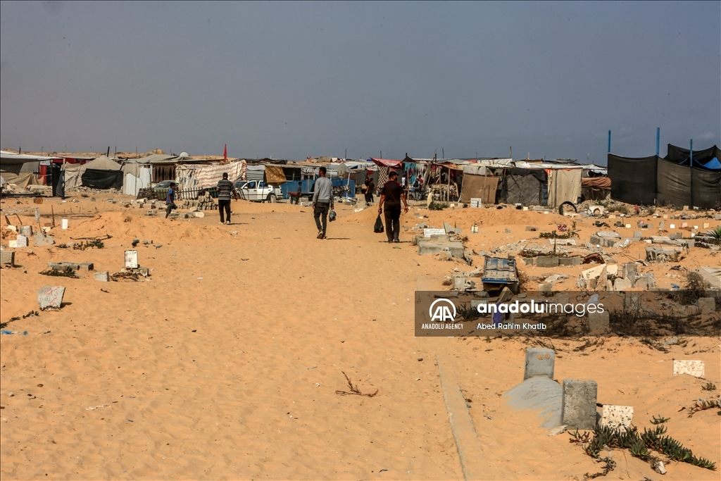 Gazan families fleeing Israeli attacks live in a cemetery