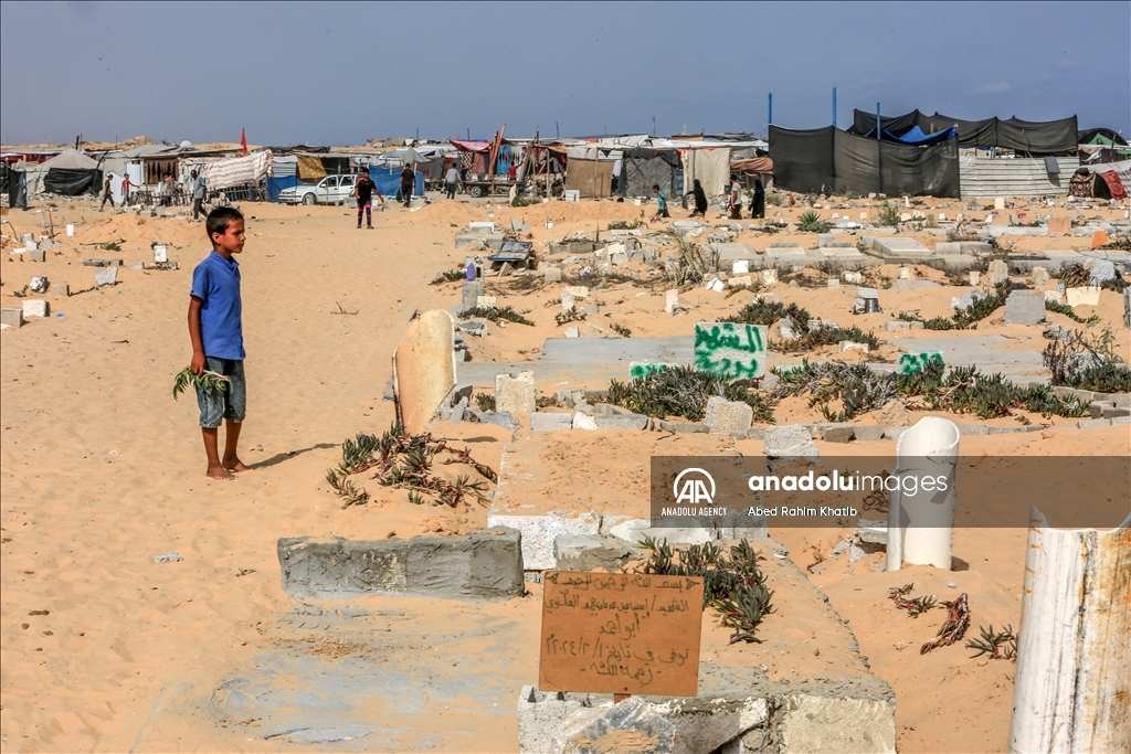 Gazan families fleeing Israeli attacks live in a cemetery