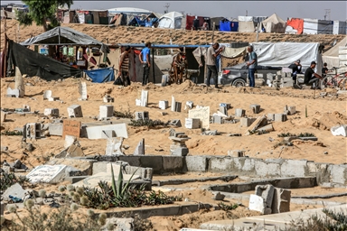 Gazan families fleeing Israeli attacks live in a cemetery