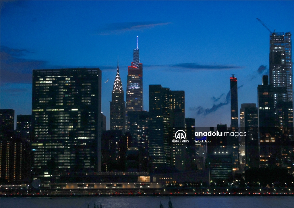 Crescent moon rises over New York City skyline
