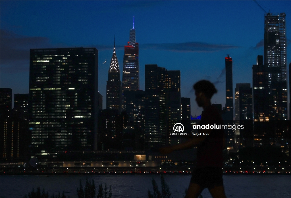 Crescent moon rises over New York City skyline