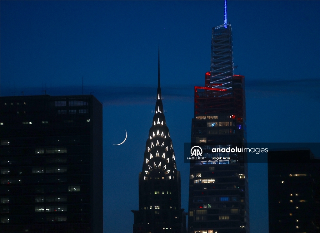 Crescent moon rises over New York City skyline