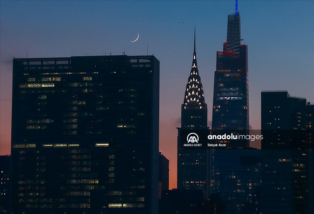 Crescent moon rises over New York City skyline