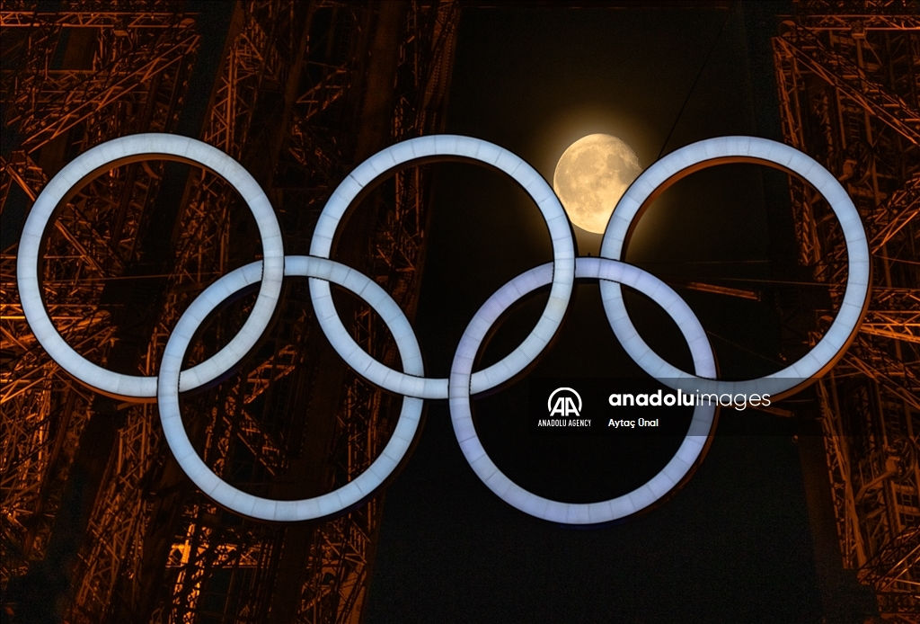 Луна выравнилась между олимпийскими кольцами на Эйфелевой башне
