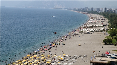 People of Antalya flock to the beaches to cool off