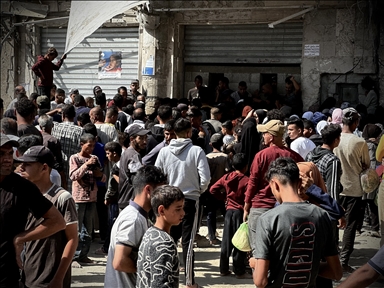 Palestinians wait long queues to buy bread from only bakery in Khan Yunis