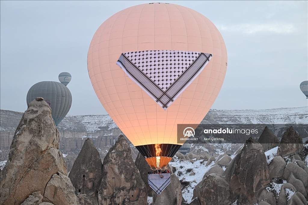 Hot air balloons with "Palestinian keffiyeh" pattern rise above Cappadocia