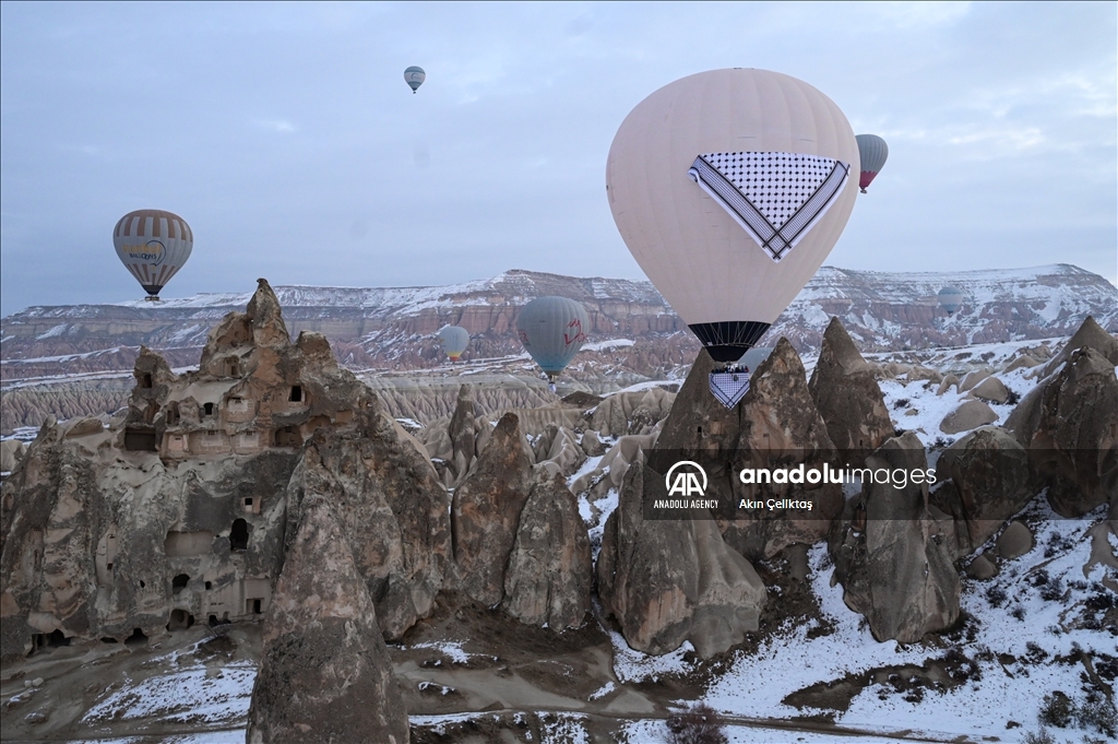 Hot air balloons with "Palestinian keffiyeh" pattern rise above Cappadocia