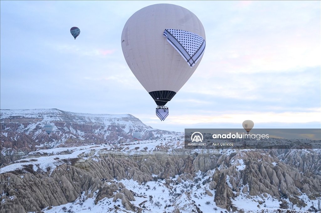 Hot air balloons with "Palestinian keffiyeh" pattern rise above Cappadocia