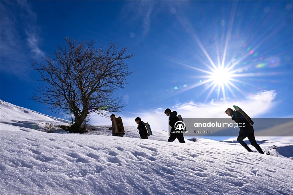 Youngsters from Bahcesaray district of Van turn the plateau road into a ski slope with their sleds