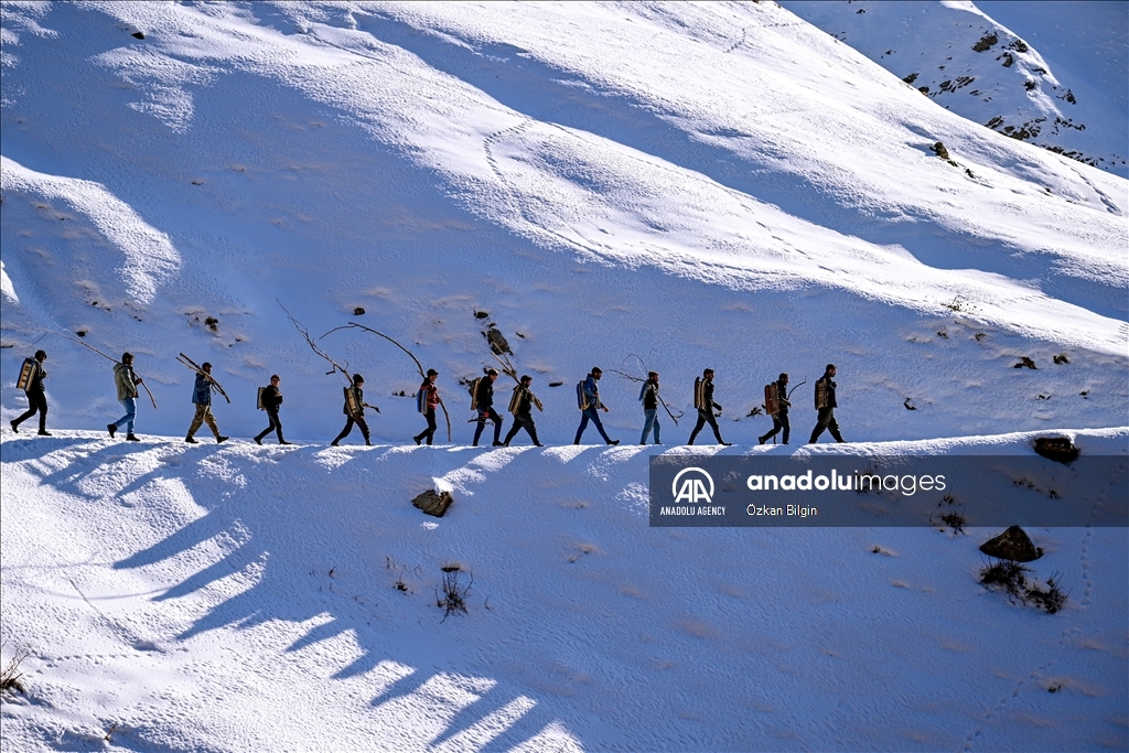 Youngsters from Bahcesaray district of Van turn the plateau road into a ski slope with their sleds