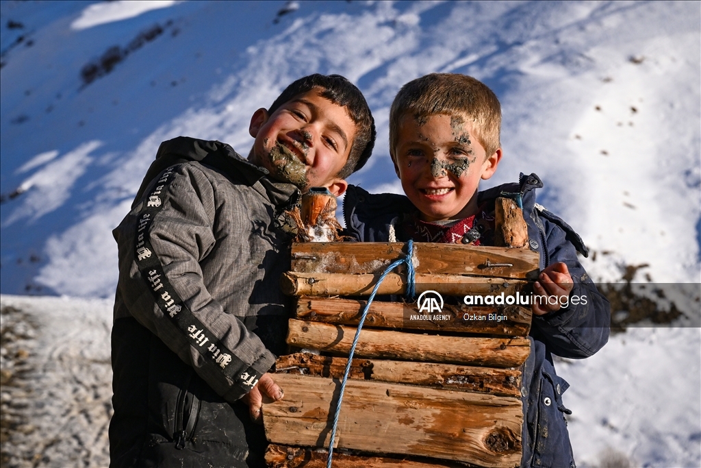 Youngsters from Bahcesaray district of Van turn the plateau road into a ski slope with their sleds