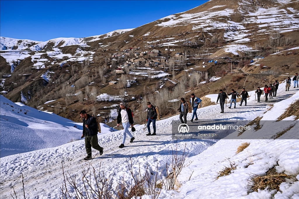 Youngsters from Bahcesaray district of Van turn the plateau road into a ski slope with their sleds