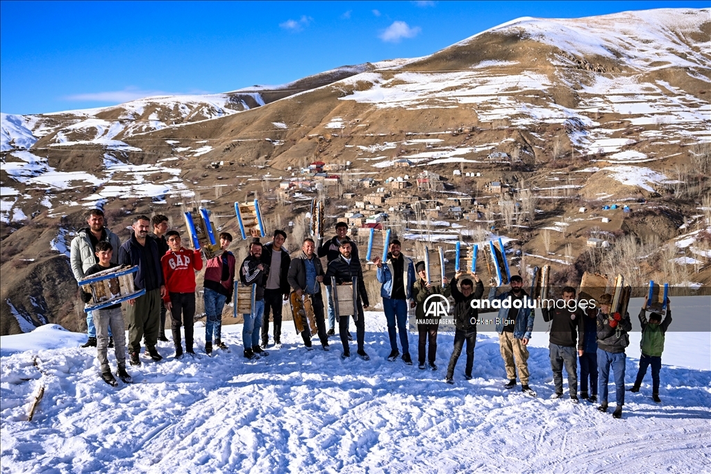 Youngsters from Bahcesaray district of Van turn the plateau road into a ski slope with their sleds
