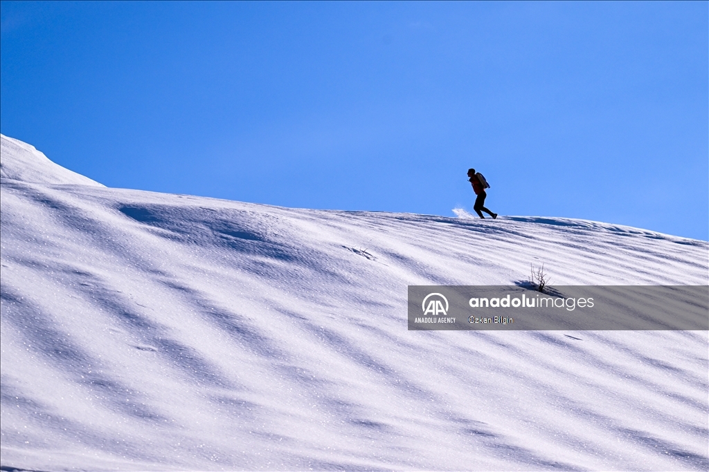 Youngsters from Bahcesaray district of Van turn the plateau road into a ski slope with their sleds