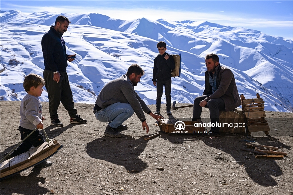 Youngsters from Bahcesaray district of Van turn the plateau road into a ski slope with their sleds