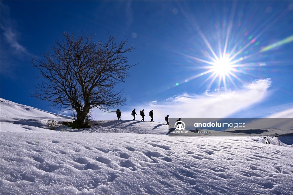 Youngsters from Bahcesaray district of Van turn the plateau road into a ski slope with their sleds