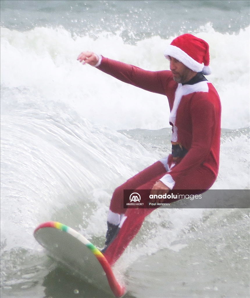 Surfing Santas Hit the Waves in Cocoa Beach, Florida