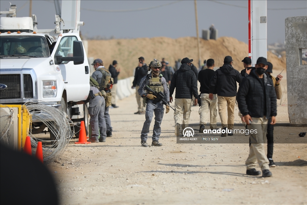 Palestinians undergo security checks as they return home after ceasefire agreement
