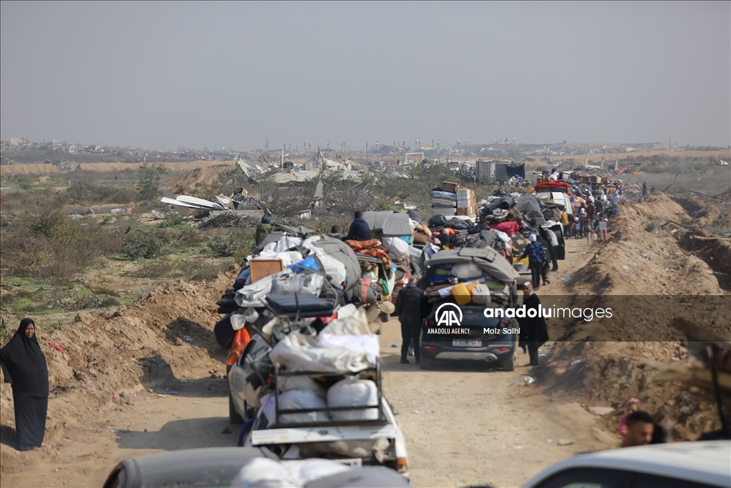 Palestinians undergo security checks as they return home after ceasefire agreement