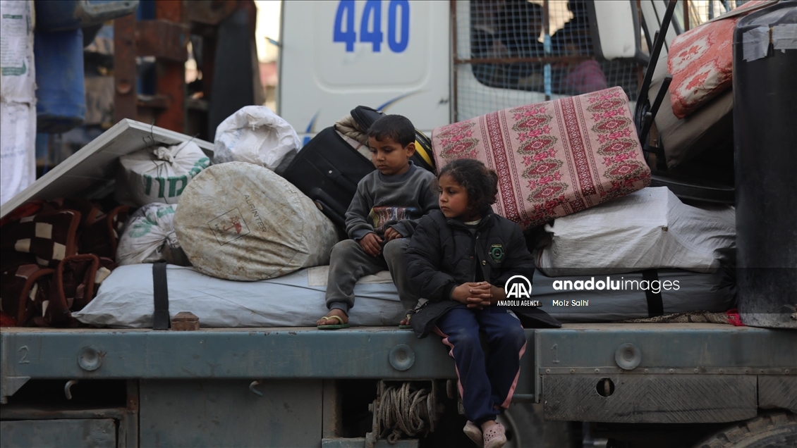 Palestinians undergo security checks as they return home after ceasefire agreement