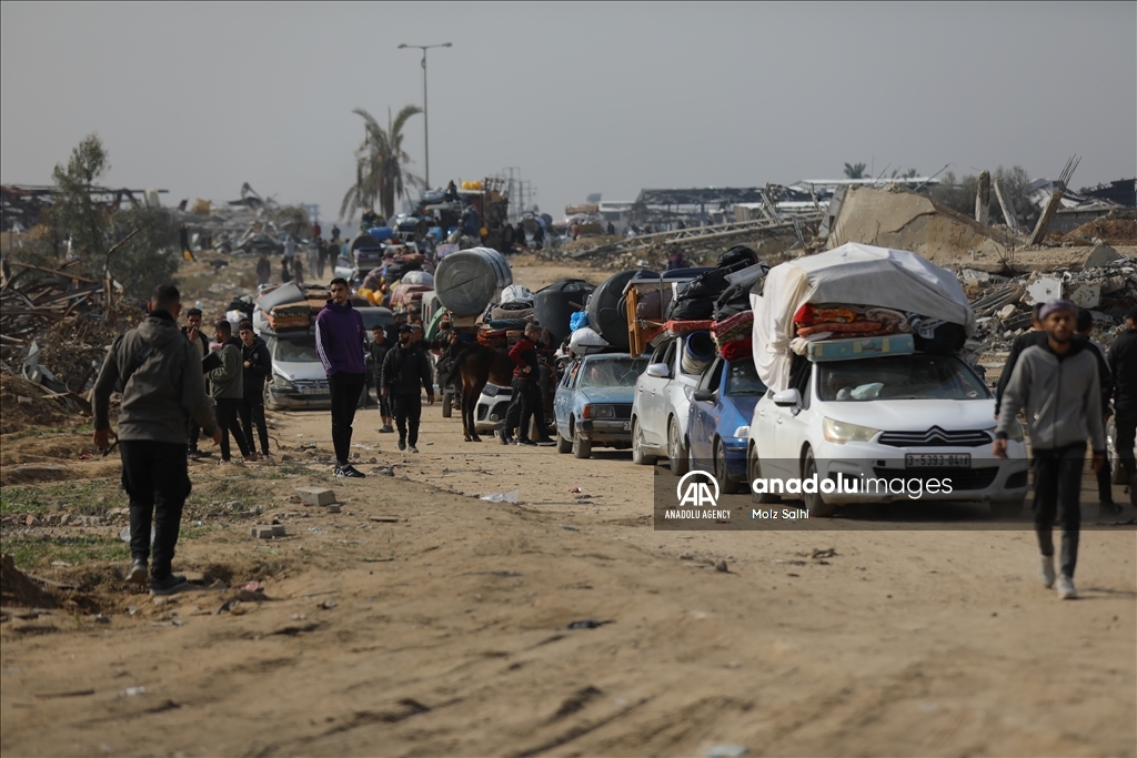 Palestinians undergo security checks as they return home after ceasefire agreement