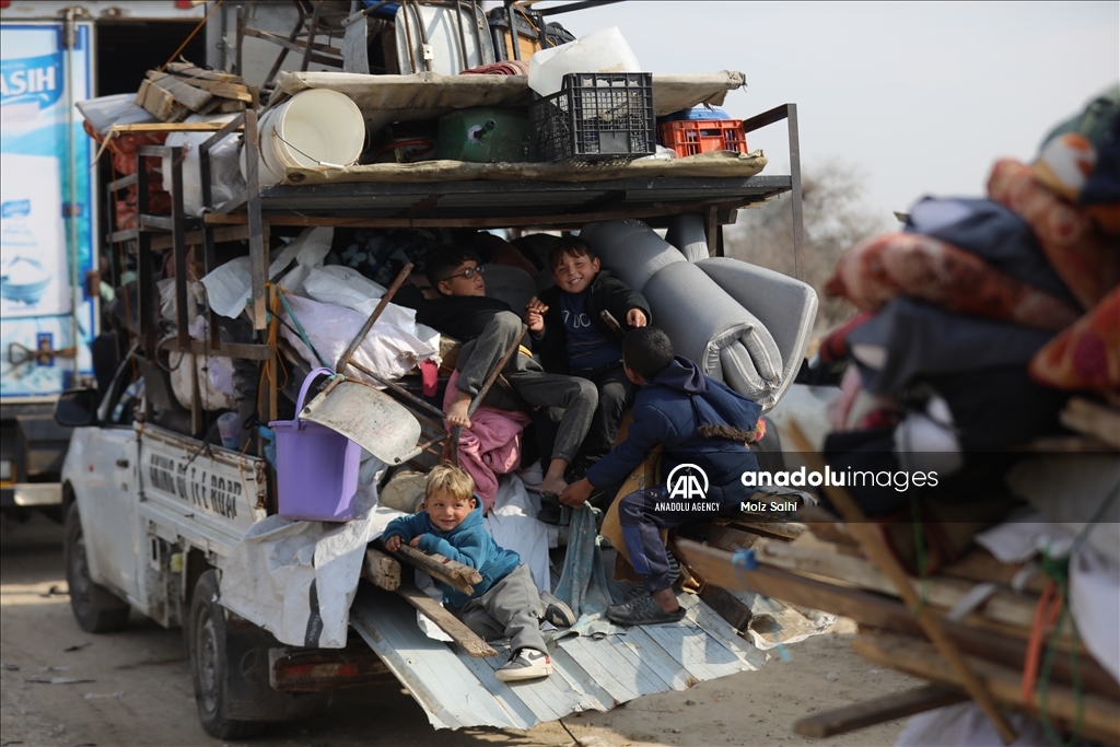 Palestinians undergo security checks as they return home after ceasefire agreement