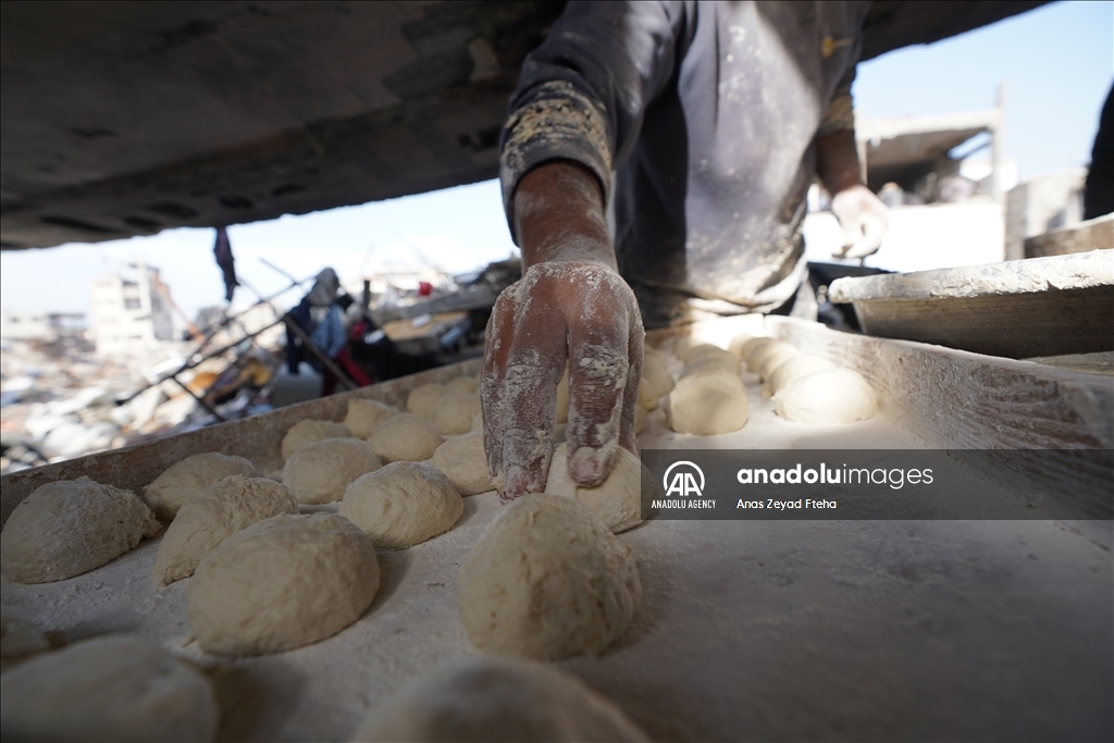 Palestinian family produces bread in rubble of their house destroyed in Israeli attacks  