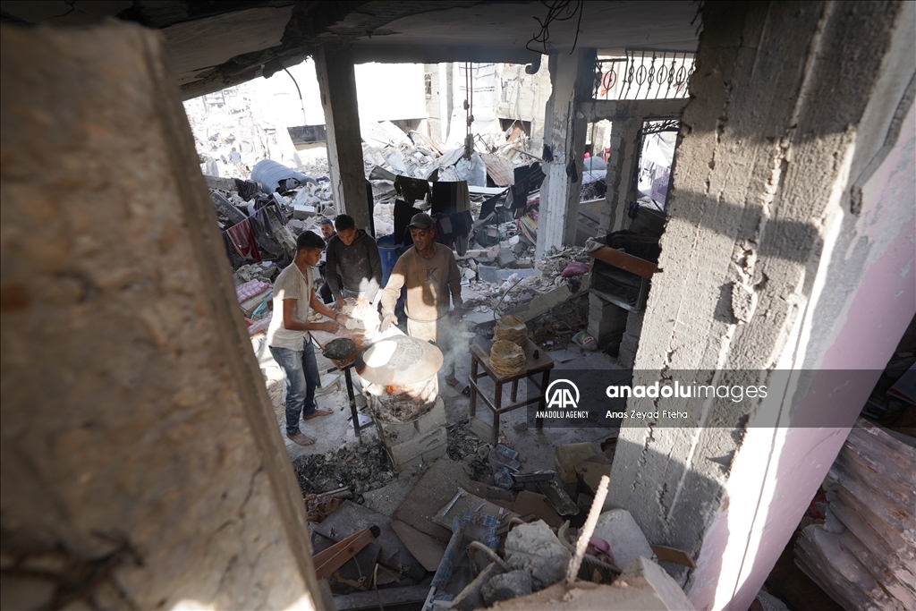 Palestinian family produces bread in rubble of their house destroyed in Israeli attacks  