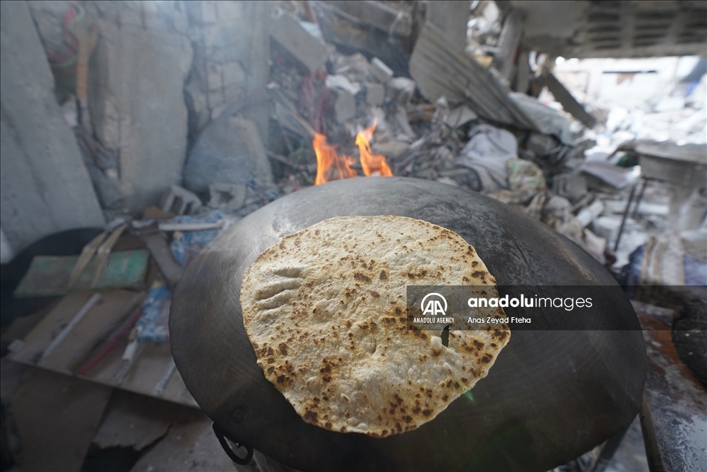 Palestinian family produces bread in rubble of their house destroyed in Israeli attacks  
