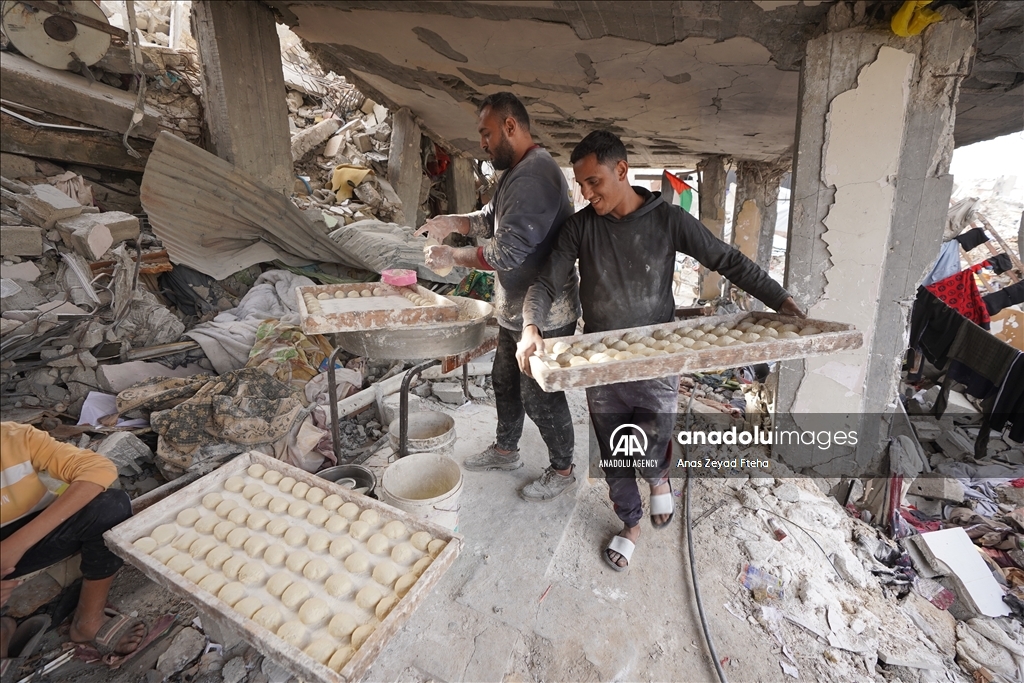 Palestinian family produces bread in rubble of their house destroyed in Israeli attacks  