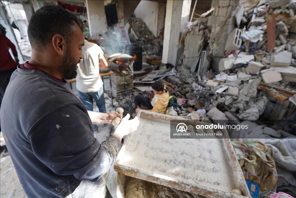 Palestinian family produces bread in rubble of their house destroyed in Israeli attacks  