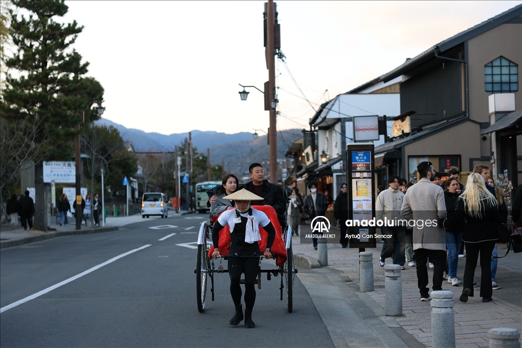 Fushimi Inari Shrine in Kyoto welcomes tourists and locals, reflecting daily life