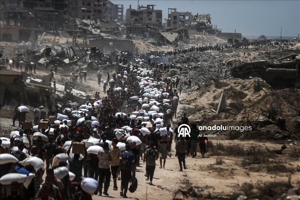 Palestinians receive limited amount of flour and infant formula at distribution point in Gaza
