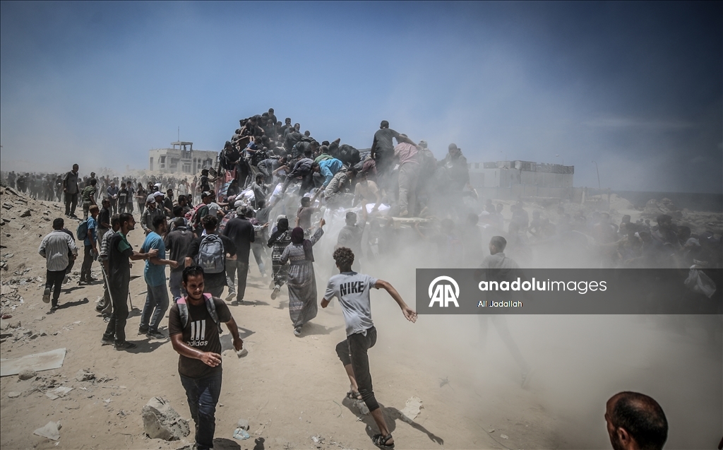 Palestinians receive limited amount of flour and infant formula at distribution point in Gaza
