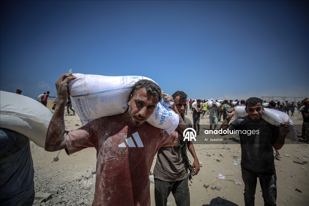 Palestinians receive limited amount of flour and infant formula at distribution point in Gaza