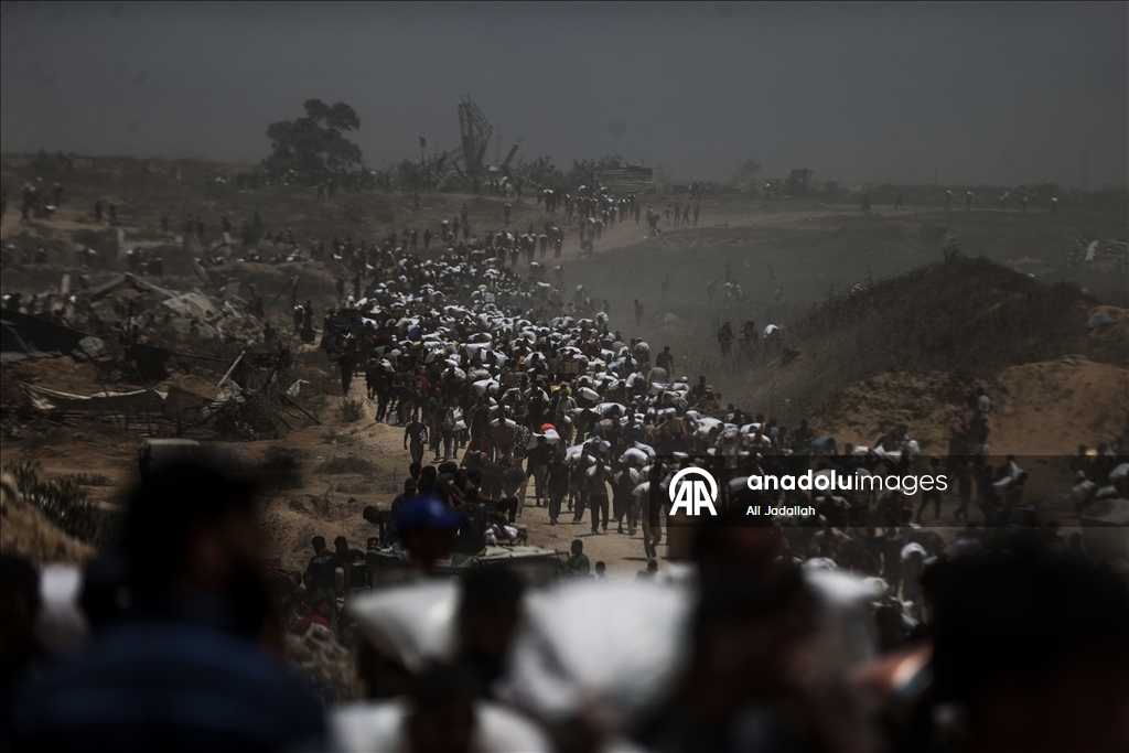 Palestinians receive limited amount of flour and infant formula at distribution point in Gaza