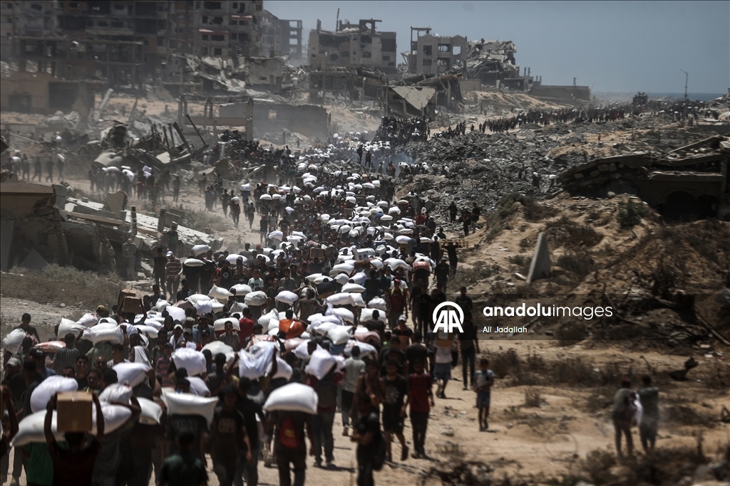 Palestinians receive limited amount of flour and infant formula at distribution point in Gaza