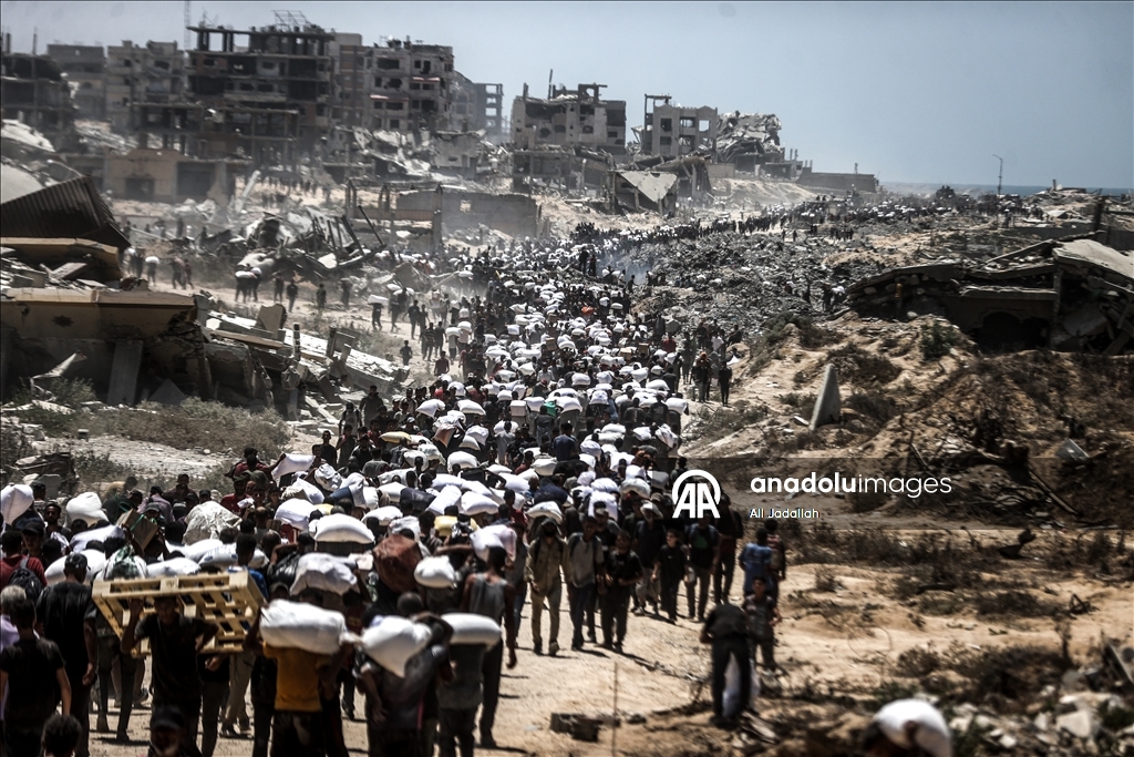Palestinians receive limited amount of flour and infant formula at distribution point in Gaza