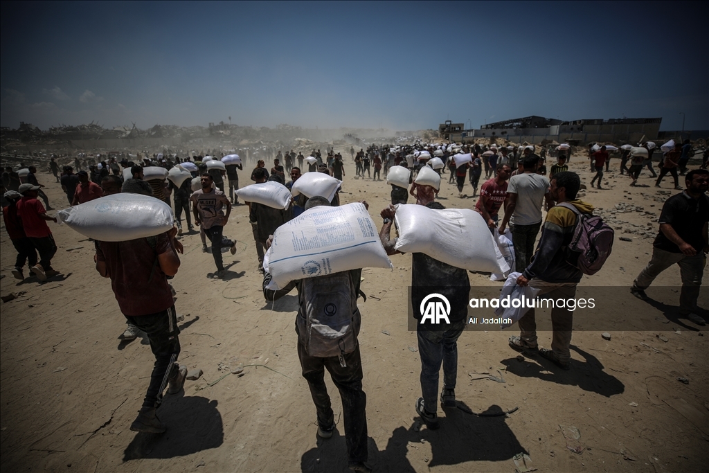 Palestinians receive limited amount of flour and infant formula at distribution point in Gaza